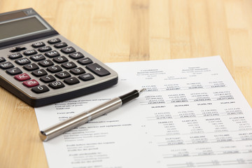Financial report with calculator on table