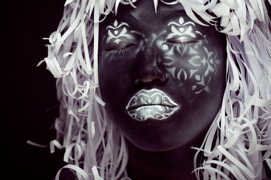Ethiopian mask, white pattern on black face with paper hair