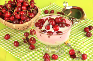 Delicious cherry dessert in glass vase on wooden table close-up