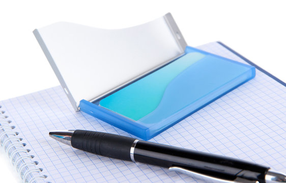 Blue business card holder, notebook and pen close-up