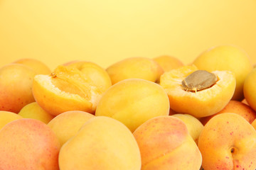 Naklejka na ściany i meble Fresh natural apricot on orange background