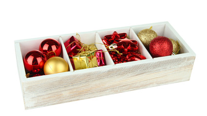 Wooden box filled with christmas decorations, isolated on white