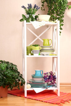 Beautiful white shelves with tableware and decor,