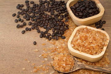 Organic rock candy sugar and coffee bean  in wooden bowl