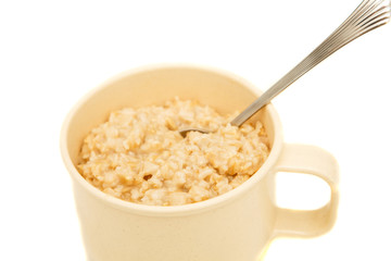 Cooked Oatmeal in a Cup with Spoon
