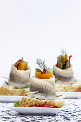 Obraz na płótnie Canvas Pickled herring rolls with vegetables