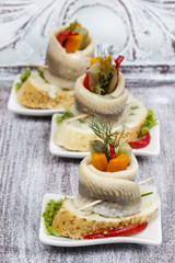 Pickled herring rolls with vegetables