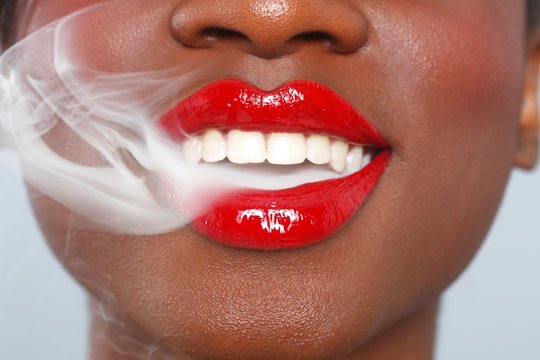 Beautiful Lips of a Woman With Cigarette Smoke