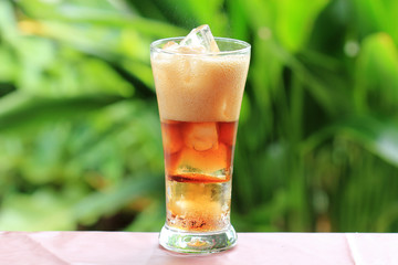 cola and ice cubes with Foam of Cola