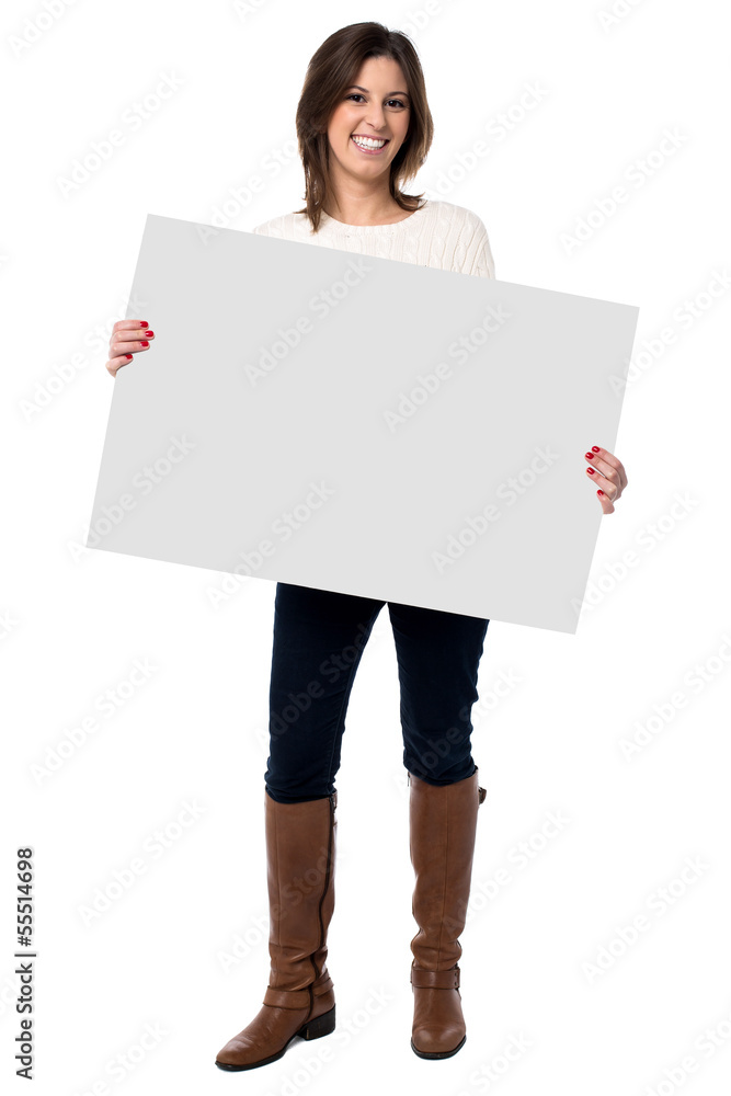 Wall mural woman holding a blank white sign