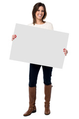 Woman holding a blank white sign