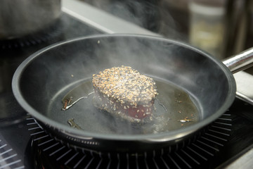 Tuna steak being fried