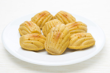homemade madeleine cookies on the plate, close-up