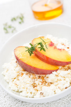 homemade cottage cheese with honey, walnuts and peaches, closeup