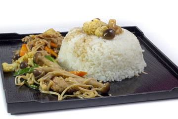 Mushrooms stir fry with rice on black plate