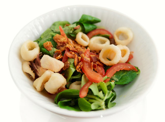 Appetizer with corn salad, fried bacon and seafood