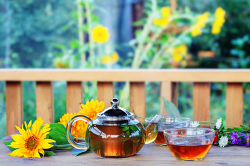 Herbal tea in teapot and cup.