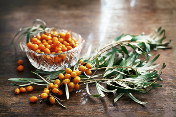sea ​​buckthorn berries on a wooden table.