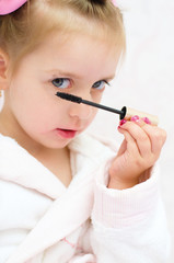 little girl painting eyes