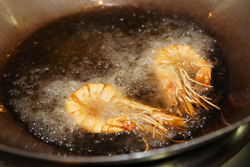 Prawns being fried in wok pan