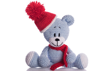 teddy bear with  scarf and bobble cap in winter