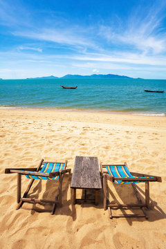 sun beach chairs on shore near sea