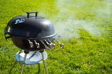 kettle barbecue grill with cover on grass