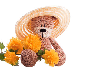 brown teddy bear with yellow blossom flower
