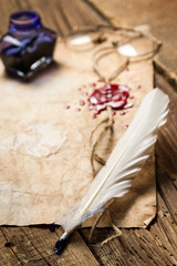 Closeup of a feather lying on vintage letter