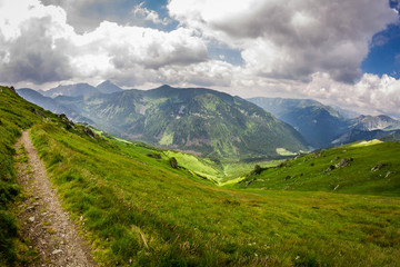 Fototapeta premium View of mountain peaks from the trail in summer