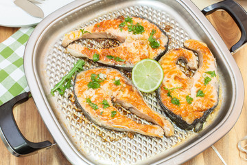 Grilled salmon steak. Three salmon steaks fried on grill pan.