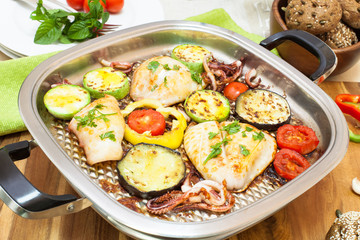 Grilled squids and vegetables on grill pan. Ready to eat.