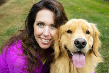 woman and her golden retriever dog