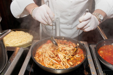 Chef frying mussels