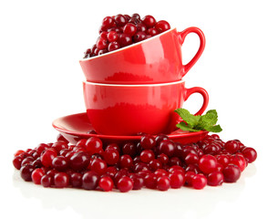 Ripe red cranberries in cups, isolated on white.