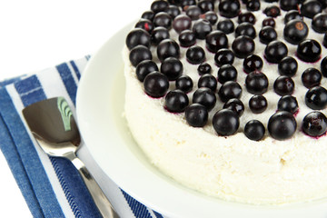 Cheesecake with fresh berries on white plate closeup