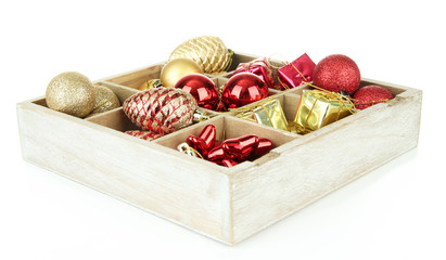 Wooden box filled with christmas decorations, isolated on white