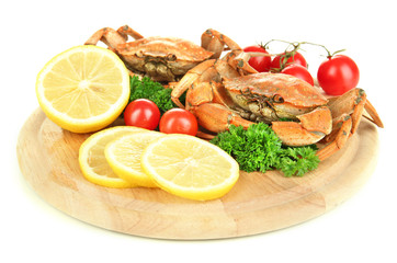 Boiled crabs with lemon slices and tomatoes,