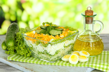 Delicious salad with eggs, cabbage and cucumbers on wooden