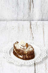 Tiramisu cake on white wooden background. Copy space