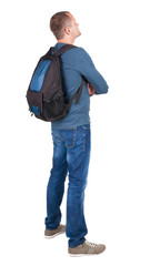 Naklejka premium Back view of man with photographic backpack looking up
