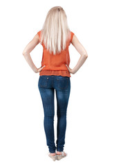 back view of standing young beautiful  blonde woman.