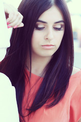 Close-up portrait of young beautiful woman with long dark hair 