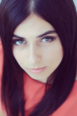 Close-up portrait of young beautiful woman with long dark hair 