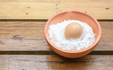 Fototapeta na wymiar egg in powder on single bowl
