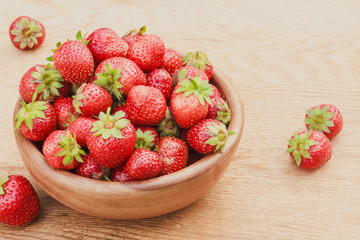Close-Up Of Strawberries In Vintage Wooden Bowl On Table