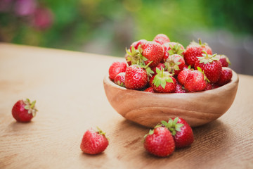 Close-Up Of Strawberries In Vintage Wooden Bowl On Table