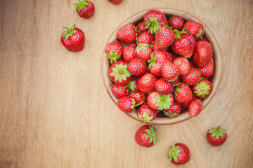 Close-Up Of Strawberries In Vintage Wooden Bowl On Table