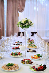 Wedding table at a wedding feast decorated with bridal bouquet