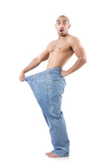 Fototapeta premium Man in dieting concept with oversized jeans